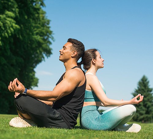 Woman sitting peacefully by the lakeside, soaking in the calm evening air.