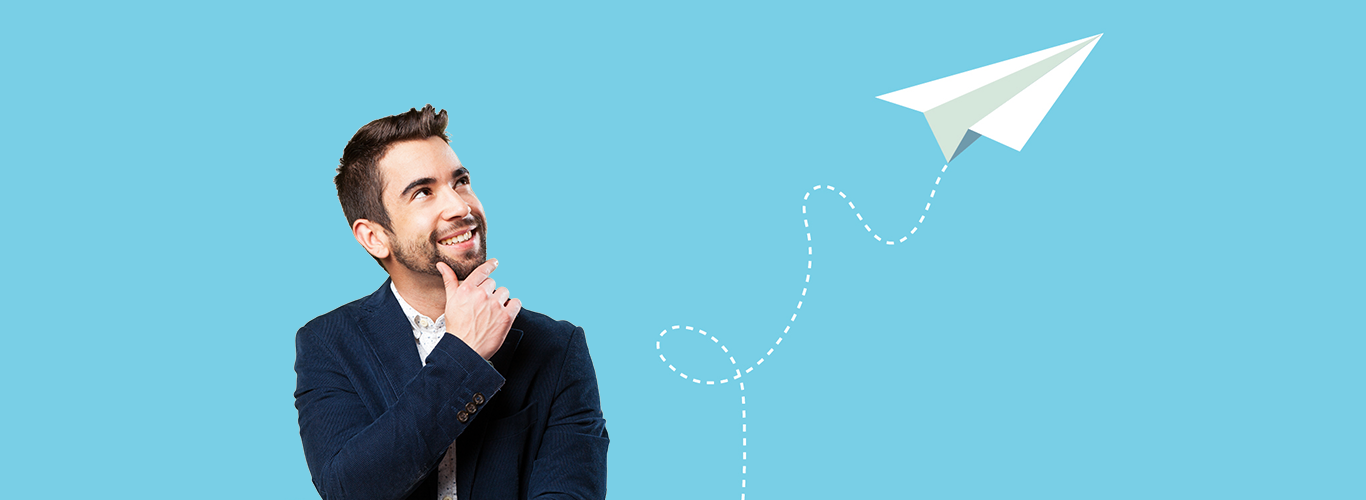 Business professional looking thoughtfully at a rising paper plane symbolising new ideas and forward growth.